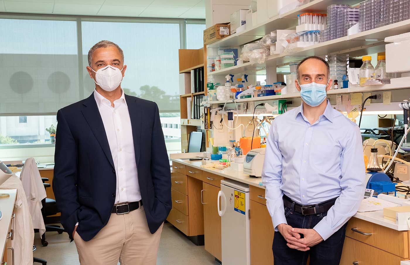 Two people in a lab wearing masks