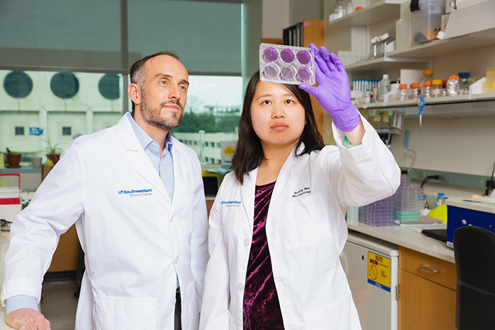 Two people in lab coats working