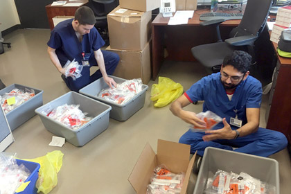 Group of medical workers sorting test kits