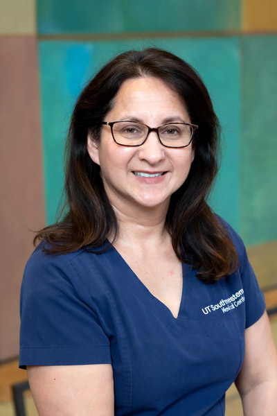 Woman with brown hair, wearing blue shirt