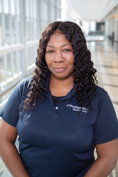 Woman with black hair, wearing blue shirt