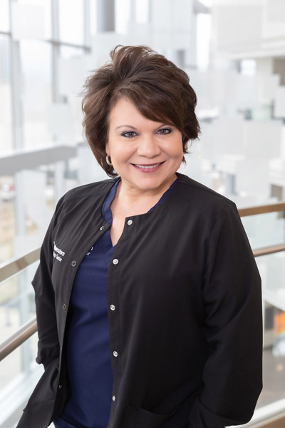 Woman with brown hair, black UTSW jacket