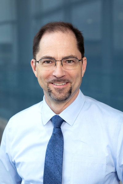 Man with glasses and blue tie