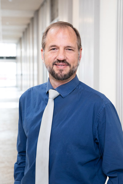 Man in blue shirt with white tie