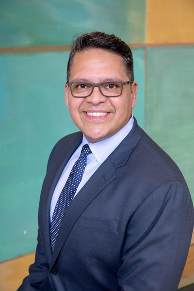 Man with glasses and blue tie