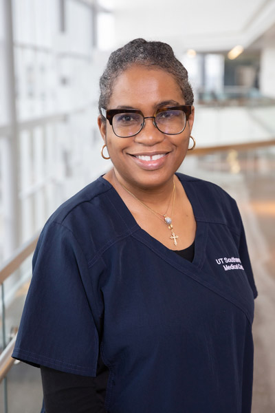 Woman with gray hair, blue scrub top