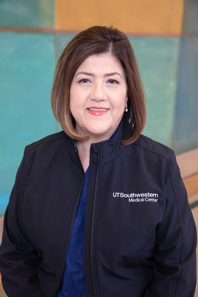 Woman with brown hair and blue UTSW jacket