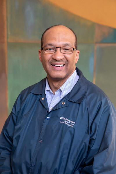 Man with glasses, with blue windbreaker