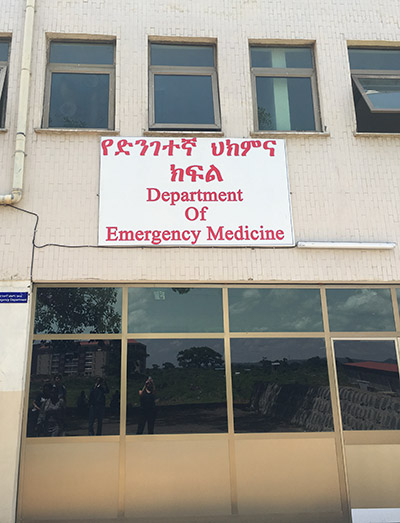 Building with a sign that reads Department of Emergency Medicine