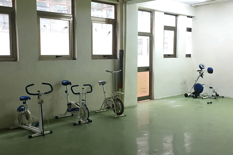 Sparse room containing a few exercise bikes