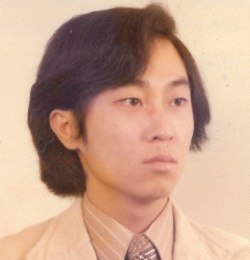 Sepia photo of young man with longer hair, wearing suit