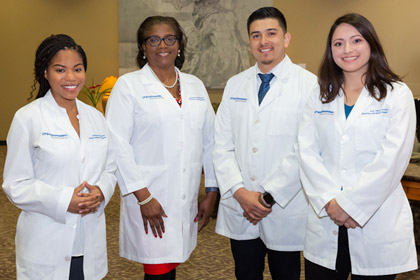Dr. Howell-Stampley with three other doctors, all wearing lab coats.