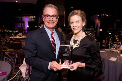 Dr. Daniel Scott and Krystle Campbell hold the award