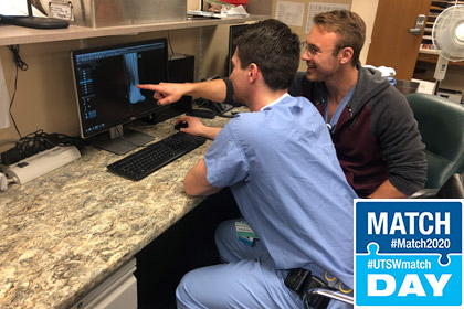 Two men looking at an x-ray on a computer