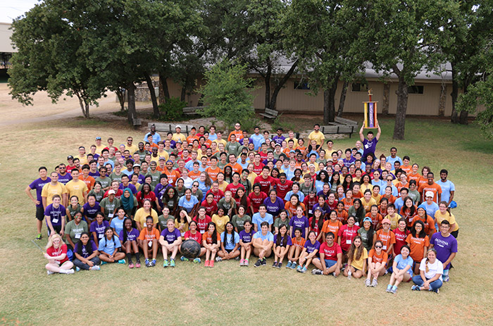 Group of students wearing shirts with different colors according to their college