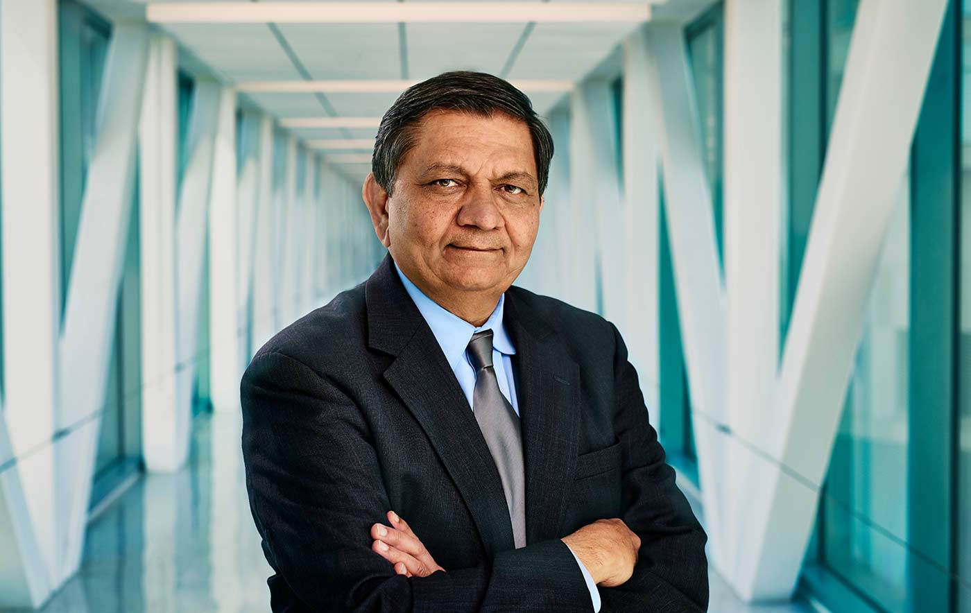 Man in suit standing in hallway.