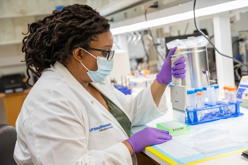 Woman in lab performing an experiment