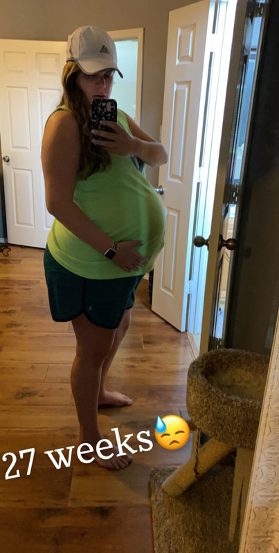 Woman in green shirt, pregnant