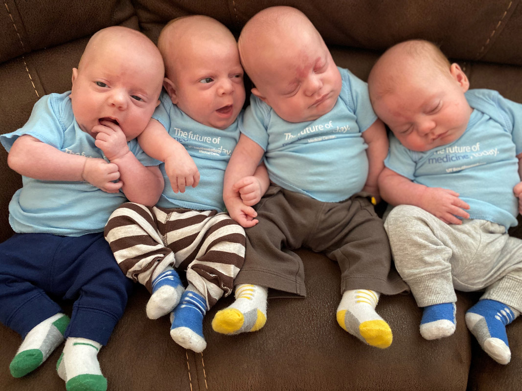 Four babies in pastel blue t shirts