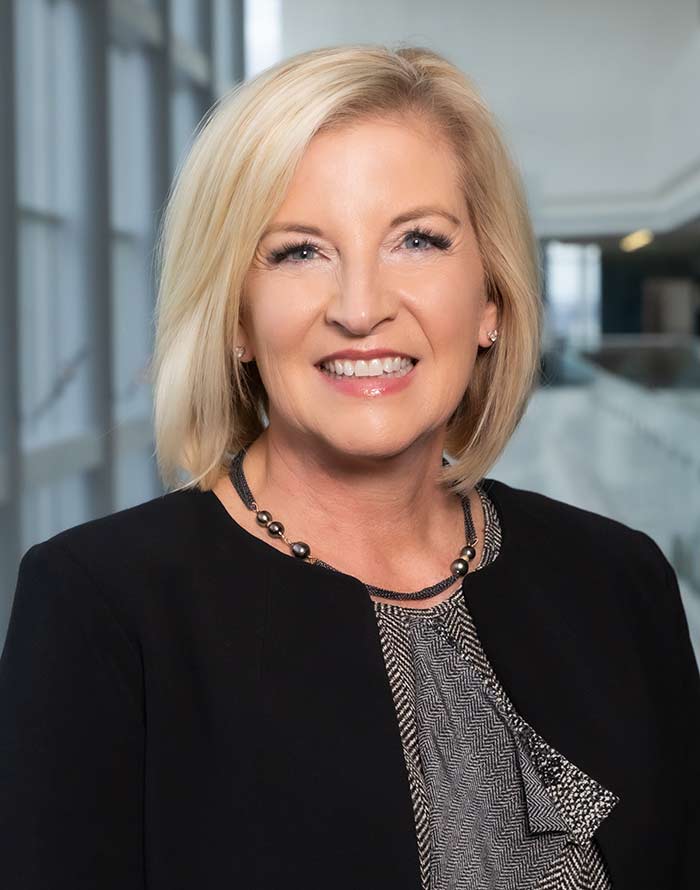 Woman with blond hair wearing black blazer