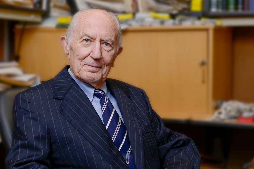 Man sitting at table wearing suit