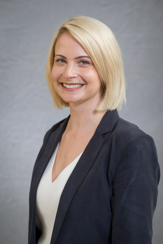 Woman in suit jacket with short blond hair