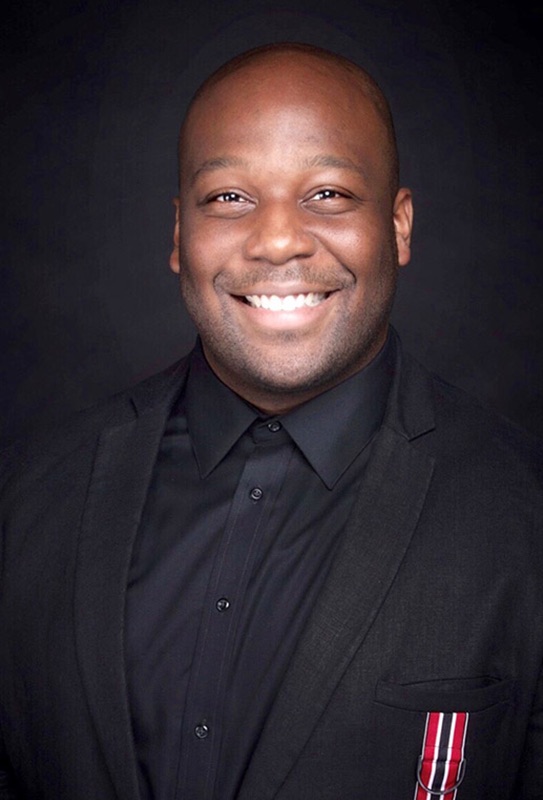 Man in black jacket, black button up shirt