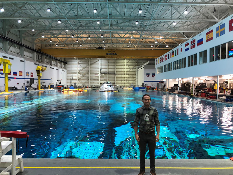 Man standing by large pool with a capsule floating in it