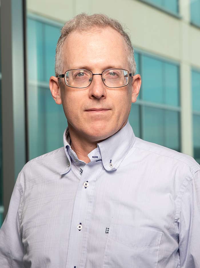 Man with glasses, blue button down shirt