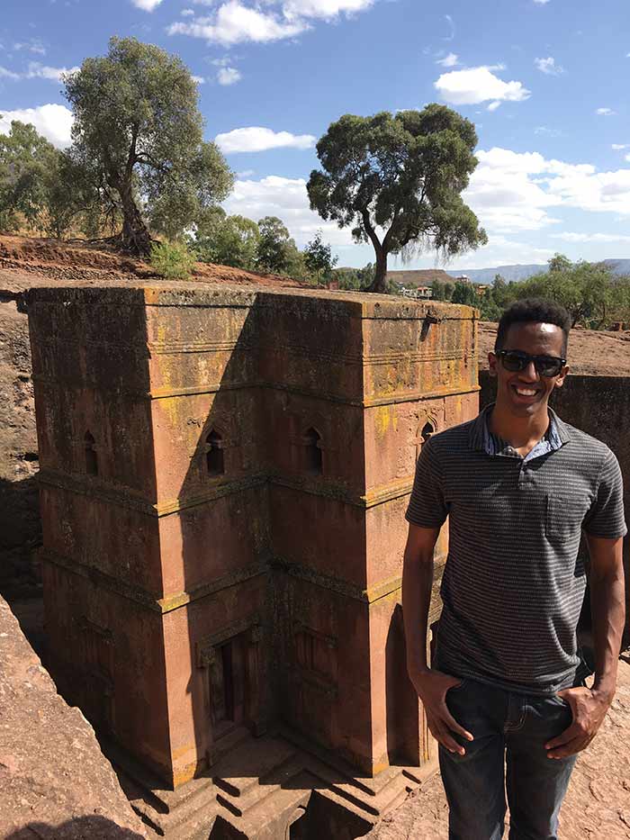 Man standing in front of stone construct