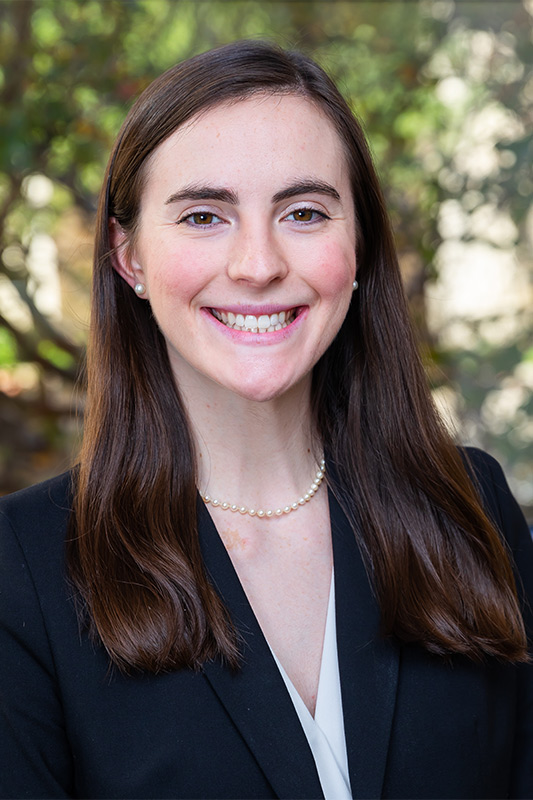 Woman with long brown hair in blue blazer