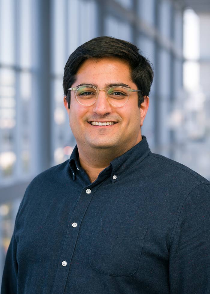 Man with glasses, navy blue shirt