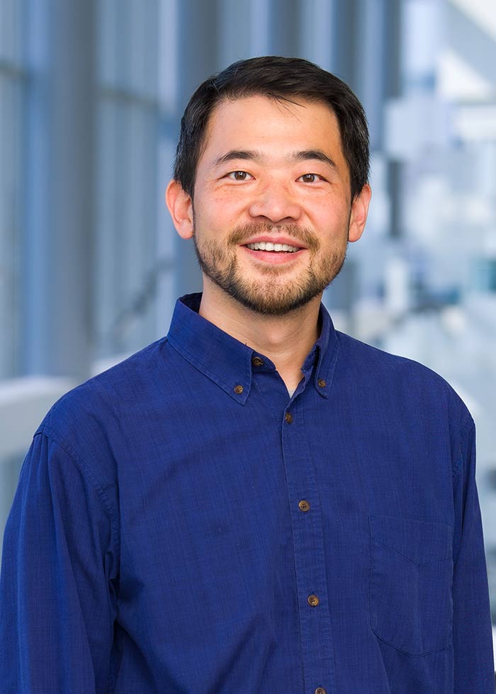 Man with short dark hair and blue button-down shirt