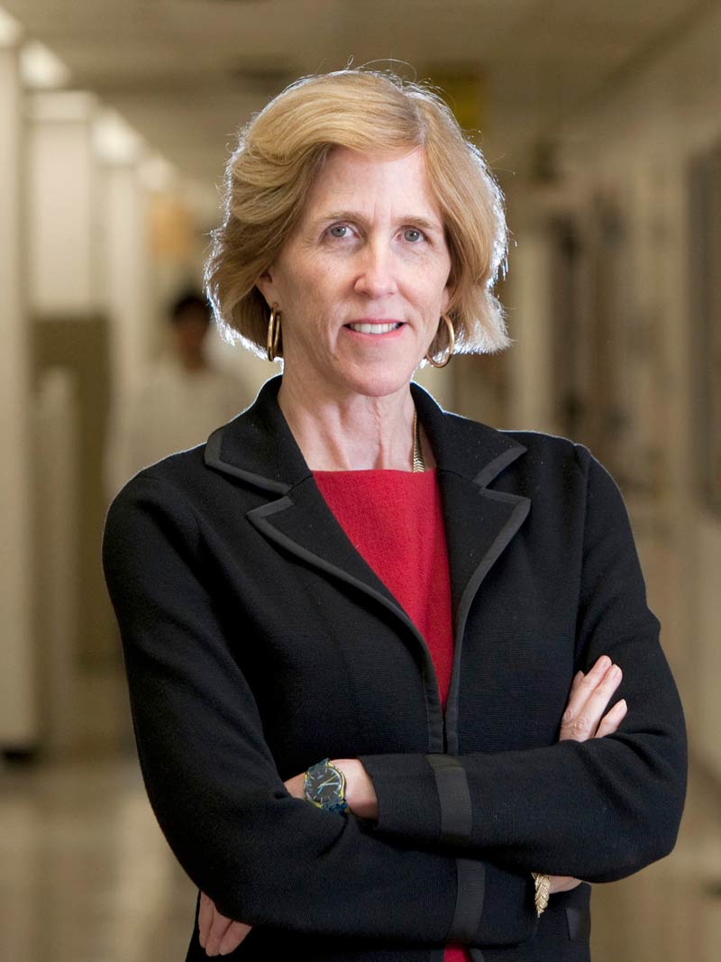 Woman with blonde hair wearing black blazer