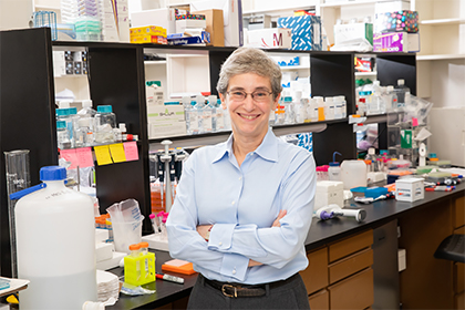 Woman in lab surrounded by colorful boxes