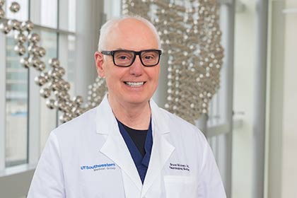 Man in glasses, white lab coat