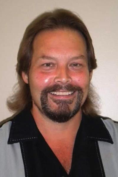 Man with beard, black and grey collared shirt