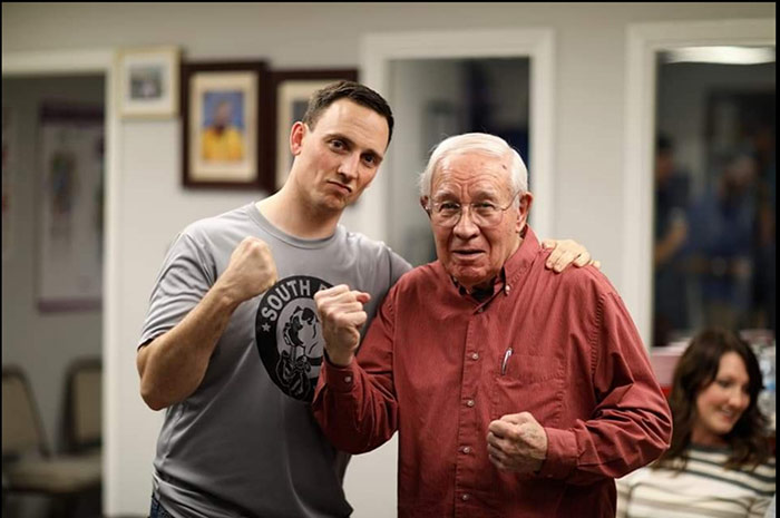 Two men, both posing in a boxing stance