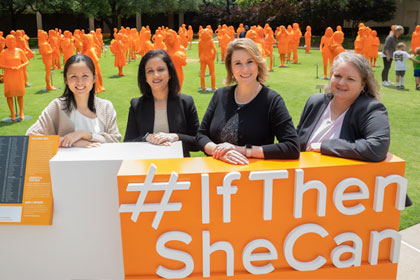 Four women in front of If/Then sign