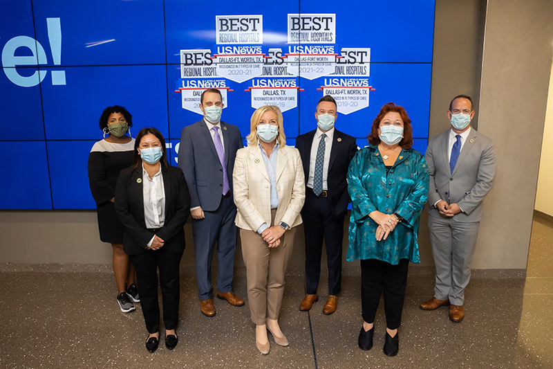 Group of people masked and standing together