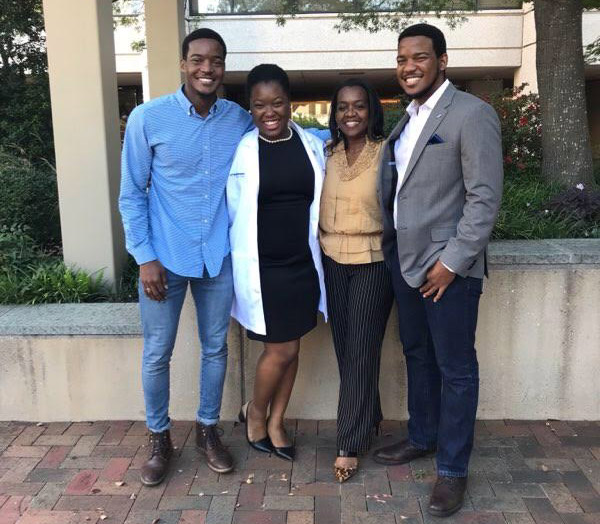 Four people standing on UTSW campus