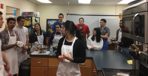 Group of people in a kitchen.