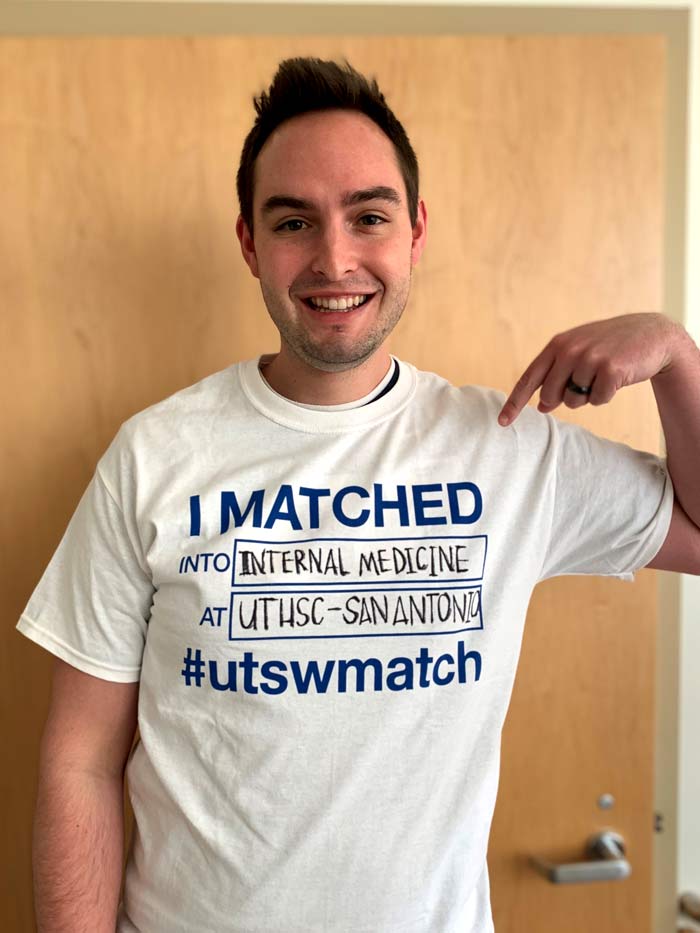 Man holding shirt that says I matched into internal medicine
