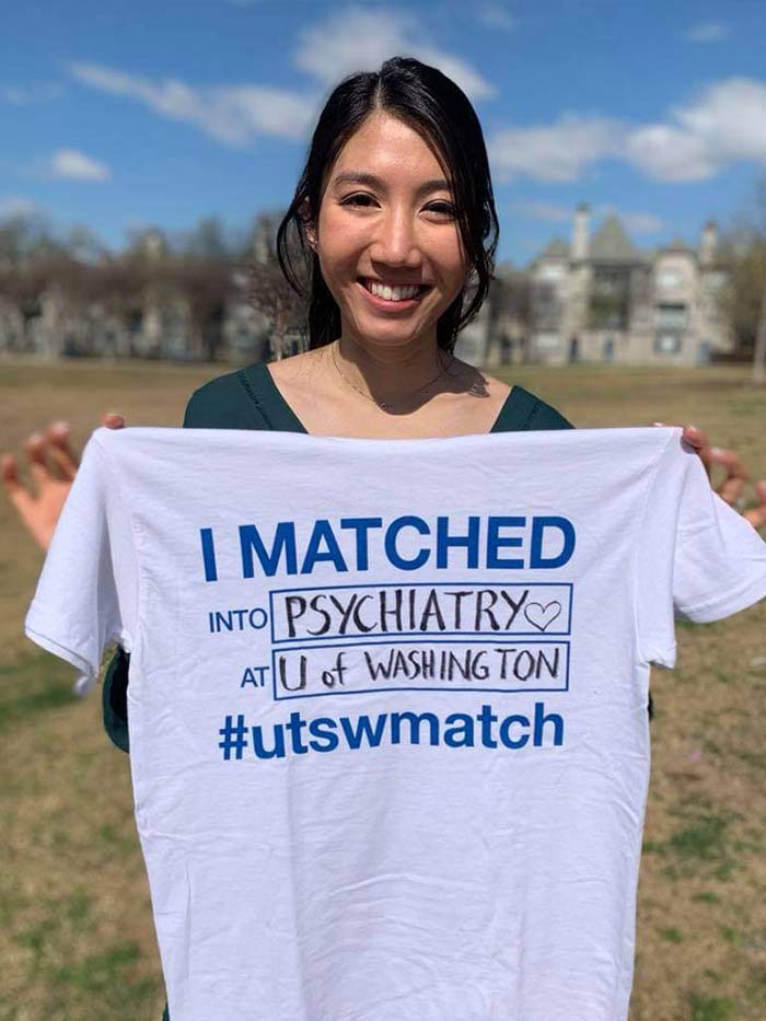 Woman holding shirt that says I matched into psychiatry