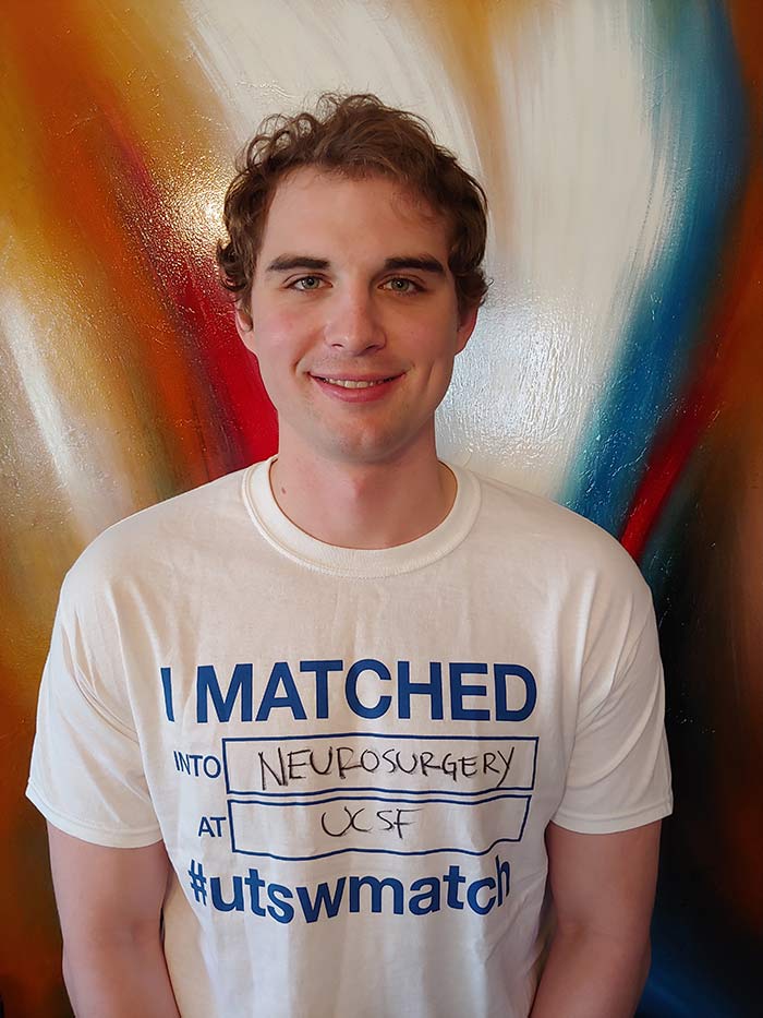 Man holding shirt that says I matched into neurosurgery