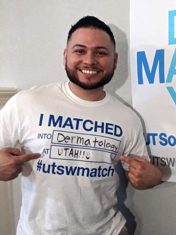 Man holding shirt that says I matched into dermatology