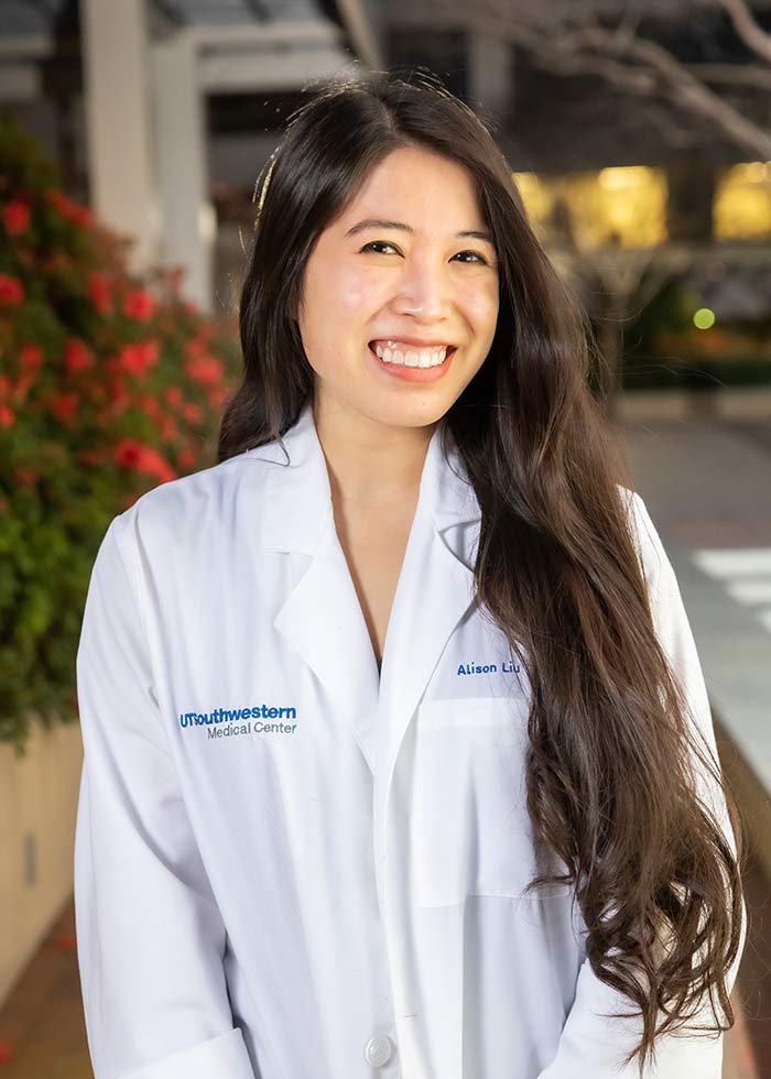 Woman with shoulder-length hair wearing a white labcoat