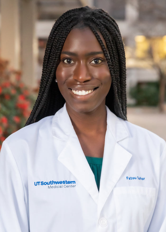 Woman with long hair wearing white lab coat