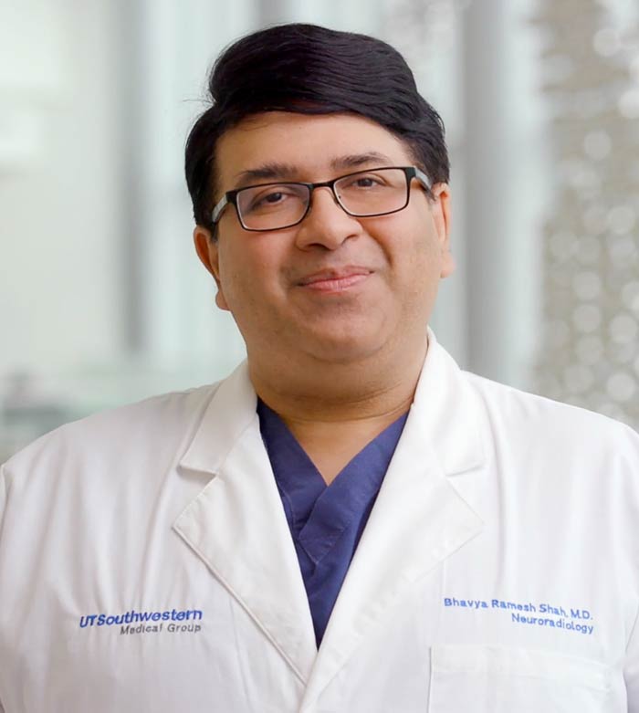 Man with black hair, white lab coat