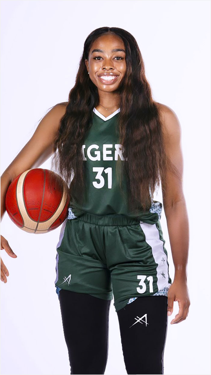 Woman in green basketball uniform that says Nigeria
